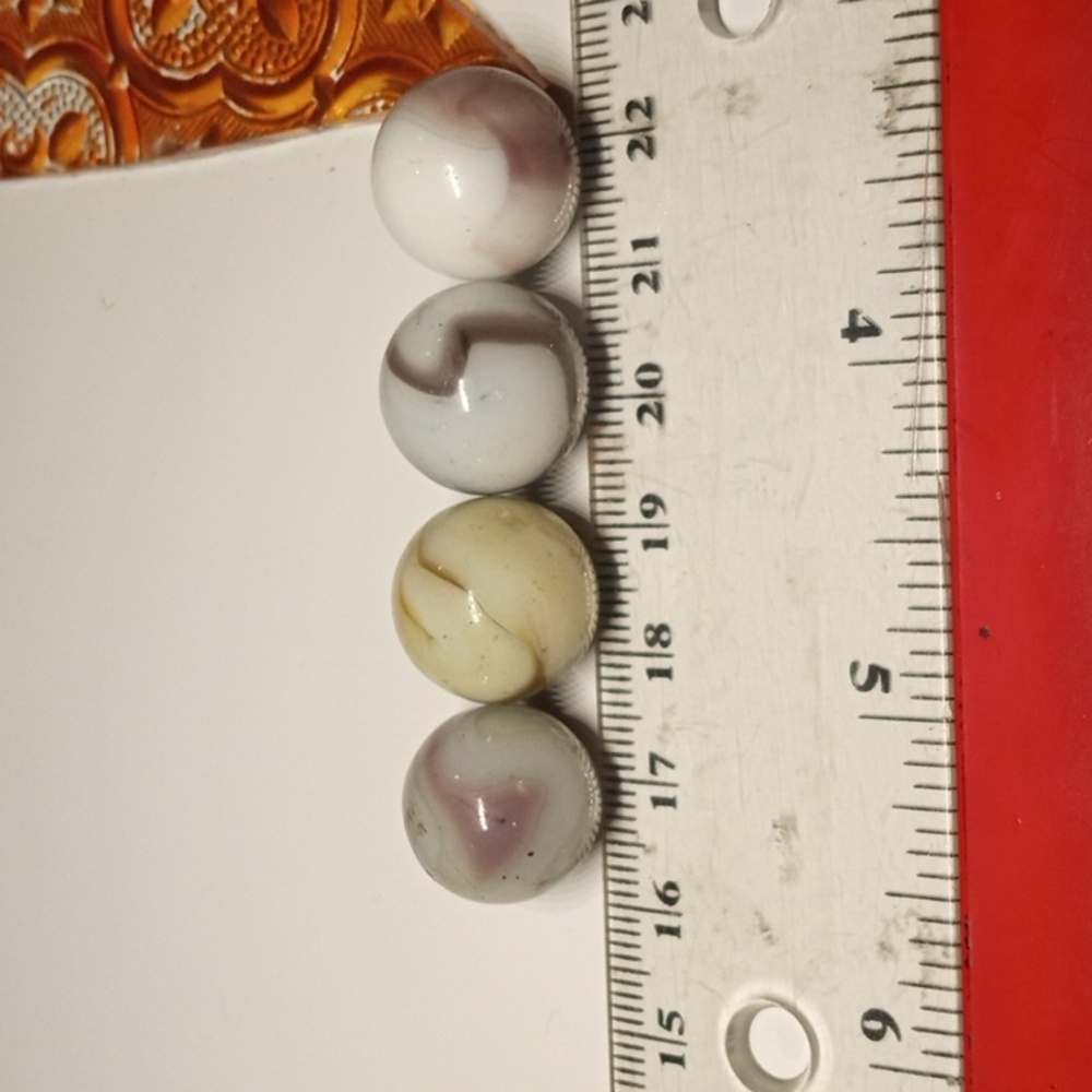 4 vintage swirl marbles. Purple and white, brown and white, yellow brown…